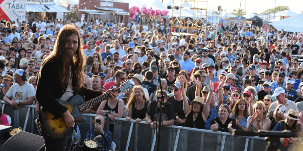 A photograph of a performer at the Hogs for the Cause event in New Orleans