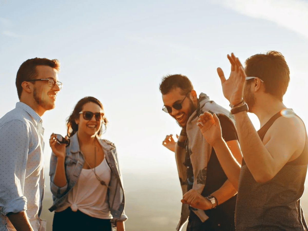 Hangover - Group of friends laughing and smiling listening to music on the phone