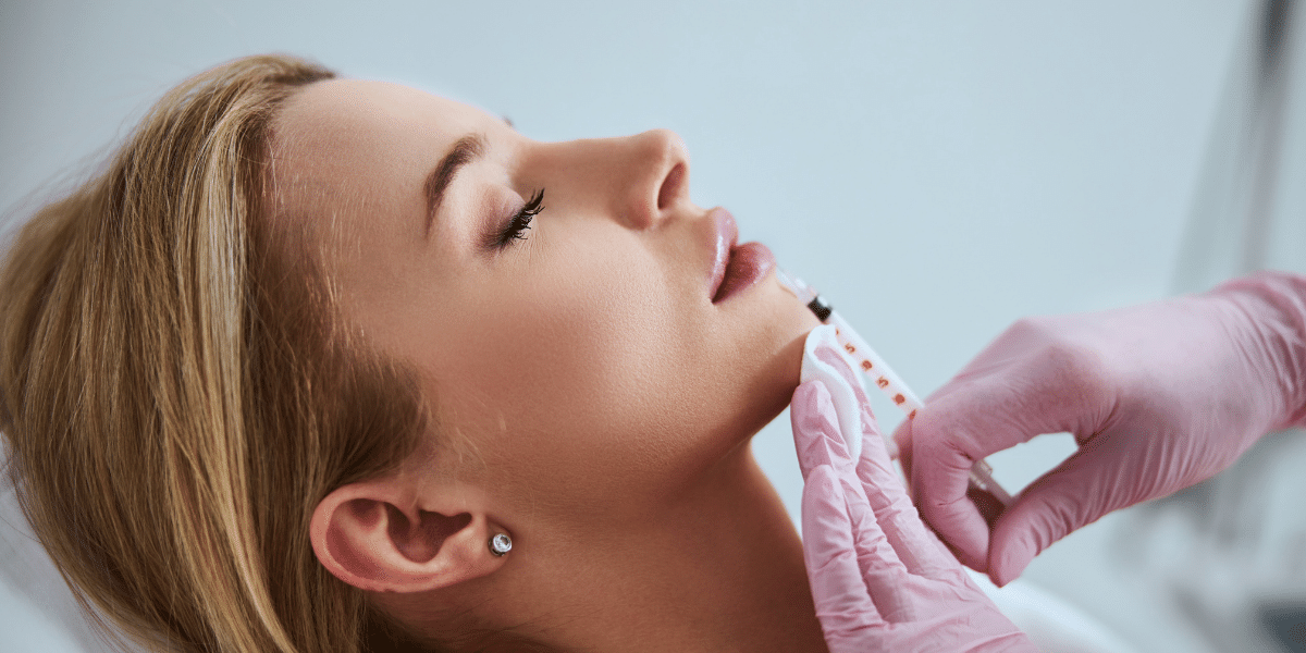 female getting lip filler by a provider wearing gloves