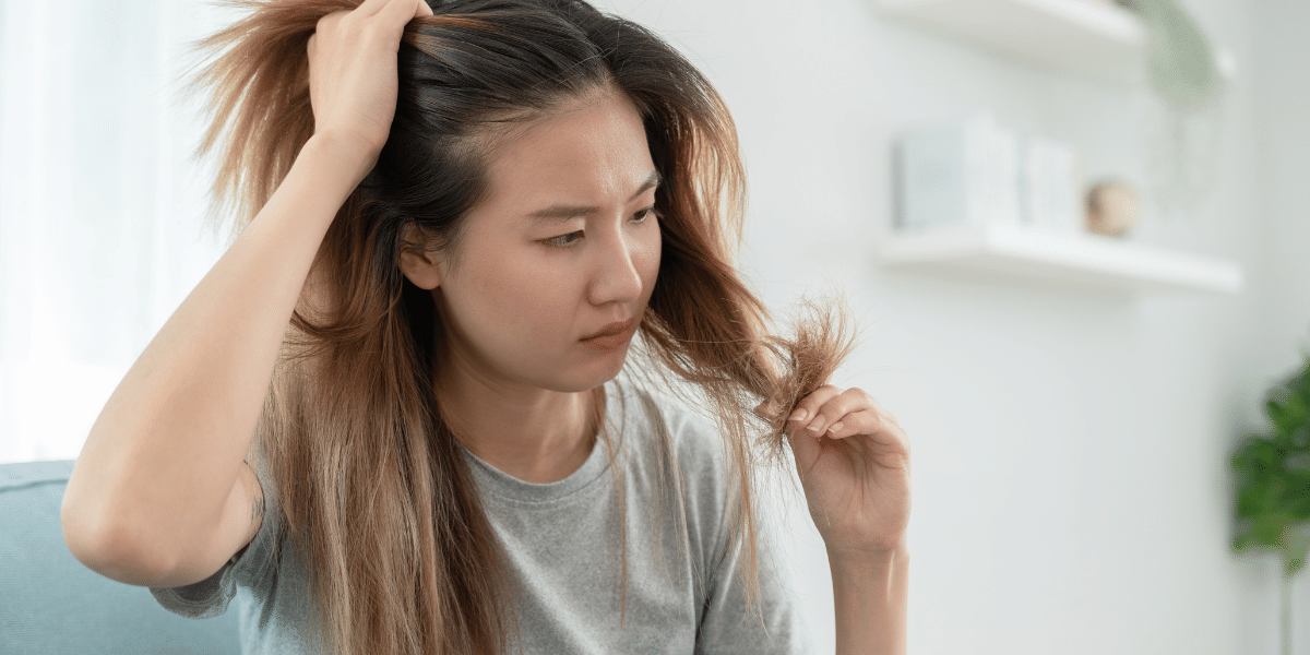 Female looking at her brittle hair