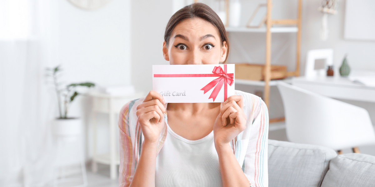 Woman holding a gift certificate in her hands