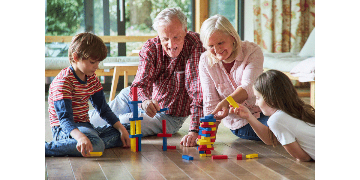 An elderly couple playing with their grandkids